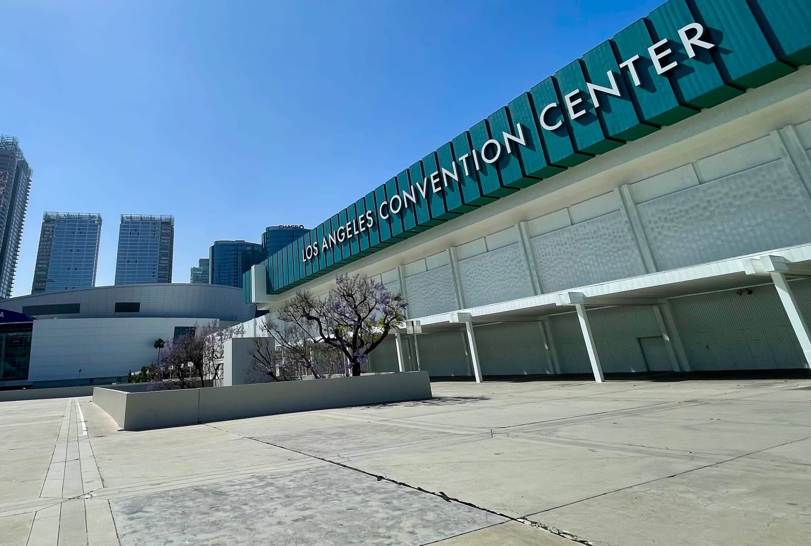 A vacant plaza in front of the oldest convention center building with signage declaring LOS ANGELES CONVENTION CENTER