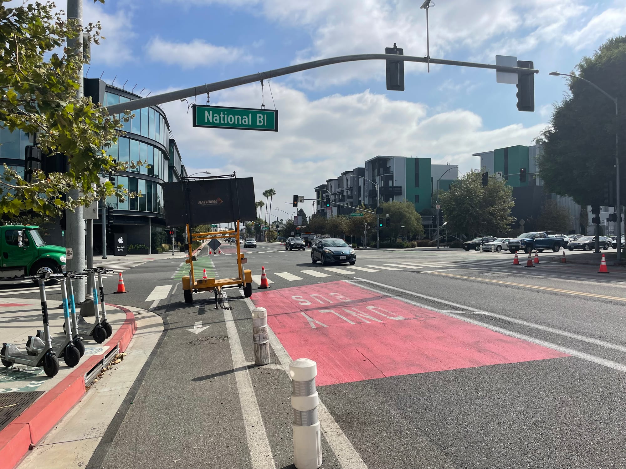 Construction on National Boulevard in Culver City with a giant sign in a bike lane next to a bus-only lane