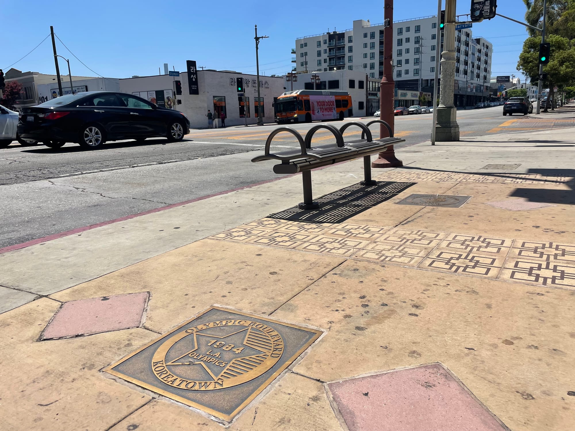 A bronze plaque that reads Olympic Boulevard 1984 Koreatown